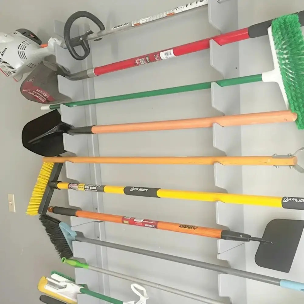 Orange-handled broom with yellow bristles and black grip displayed on Lancaster wooden wall mounted garden tool rack