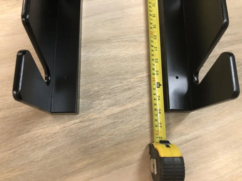 Black plastic wall-mounted phone holder with curved hook design for birch plywood wall mounted four pair ski and pole rack
