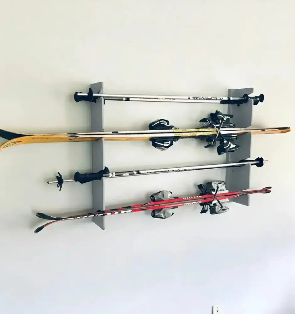 Gray birch plywood wall mounted ski and pole rack holding two pairs of skis and poles for organized storage