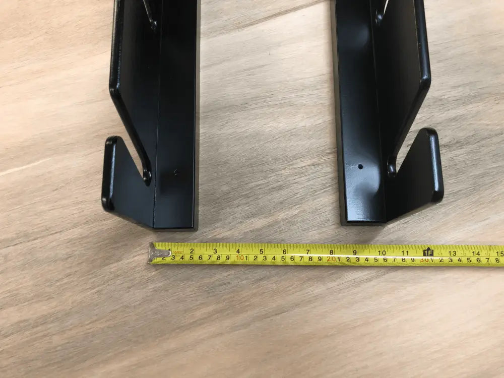 Black metal shelf brackets with matte finish and angular design for birch plywood wall mounted four pair ski and pole rack