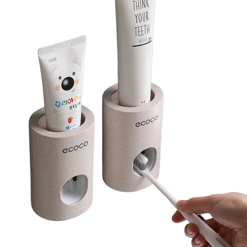 Beige textured wall mounted toothpaste dispenser and holder set with ecoco branding holding two tubes and built-in brush holder