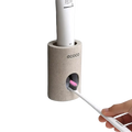 Beige textured wall mounted ecoco toothbrush holder with integrated toothpaste dispenser for bathroom organization