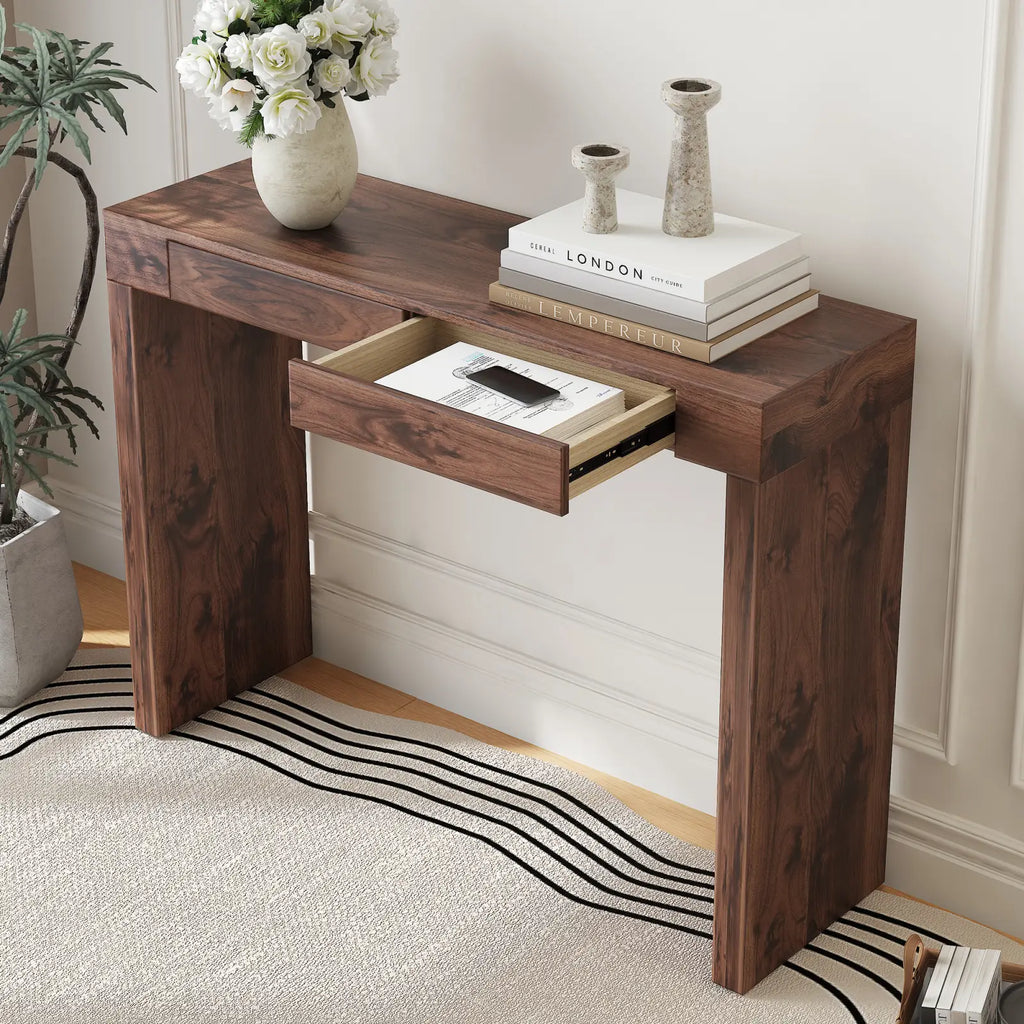 Dark brown walnut wood bar table with double drawers 50 inch showing a single drawer open with books and smartphone inside