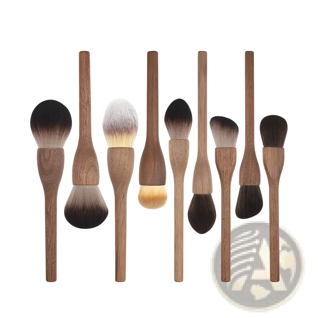 Set of eight walnut wood makeup brushes with wooden handles and soft natural fiber bristles in varying sizes and shapes