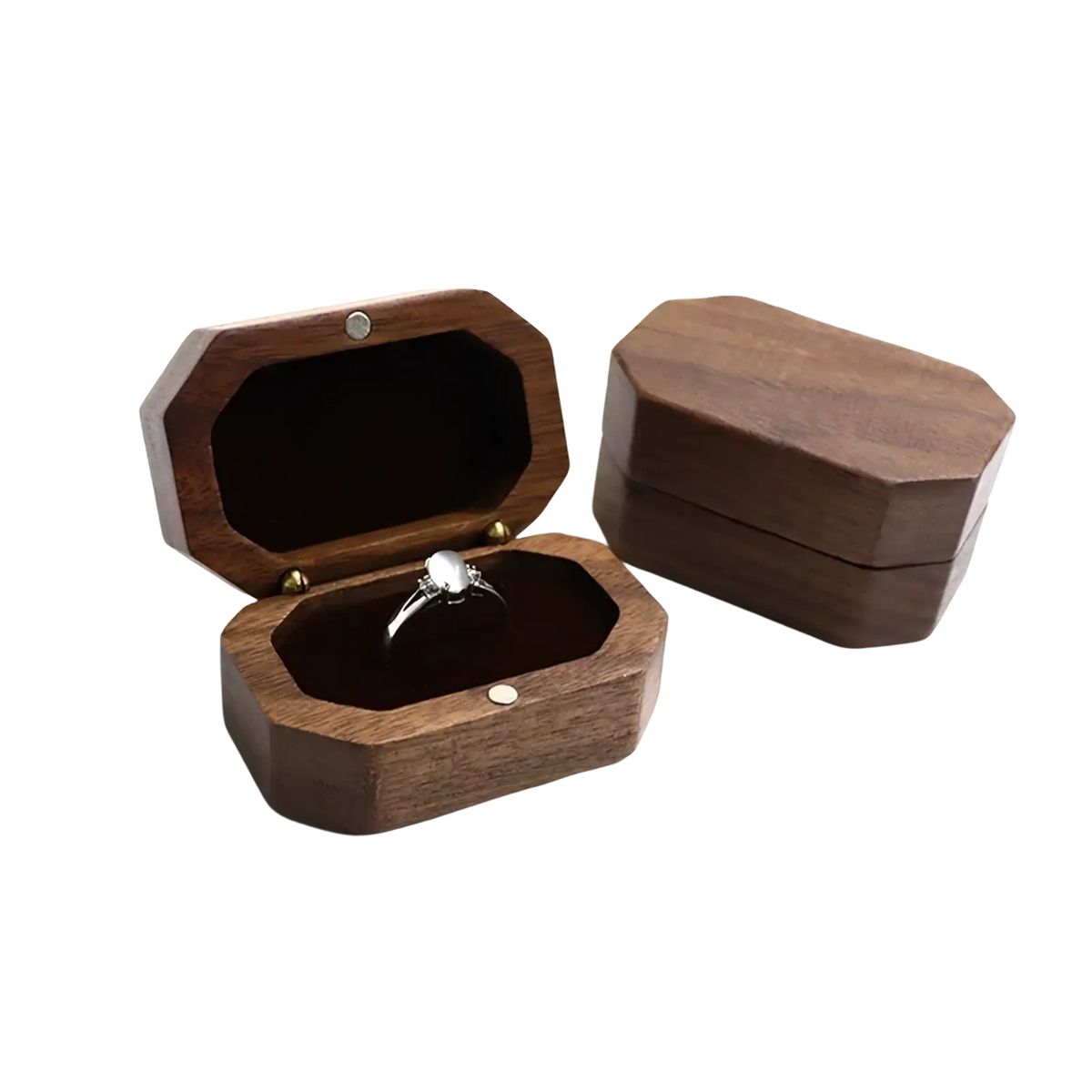 Dark brown walnut wood octagonal engagement ring box with a silver toned ring nestled inside