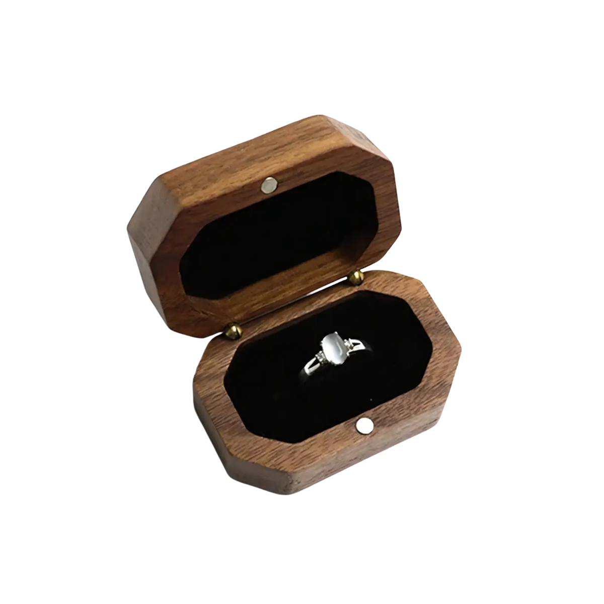 A silver ring with a rectangular faceted stone inside a walnut wood octagonal engagement ring box lined with black velvet