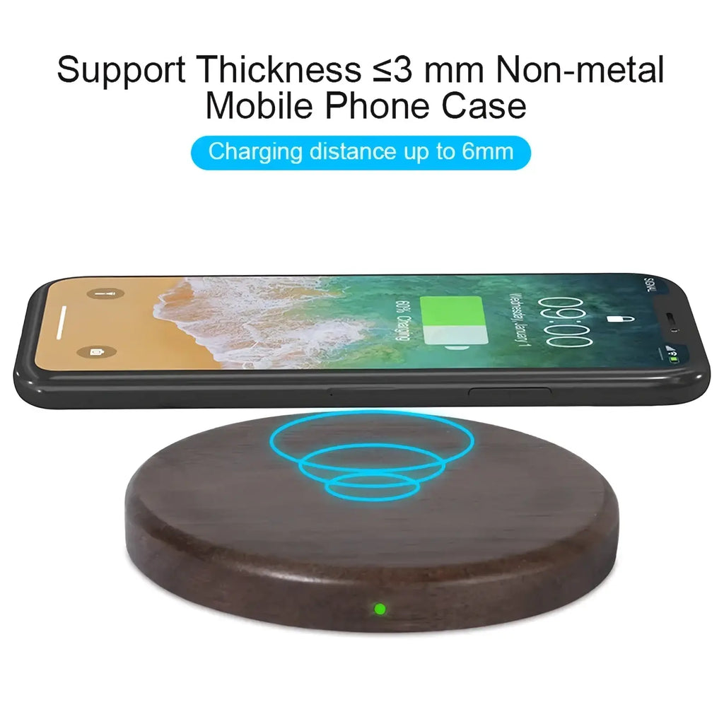 Dark wood walnut wireless charging pad 15w with glowing blue charging symbol and green indicator light