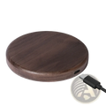 A sleek dark brown walnut wood wireless charging pad with a 15w usb-c port for fast charging
