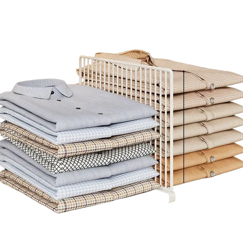 White metal wardrobe divider organizer with vertical slats and base holding folded shirts in various colors and patterns