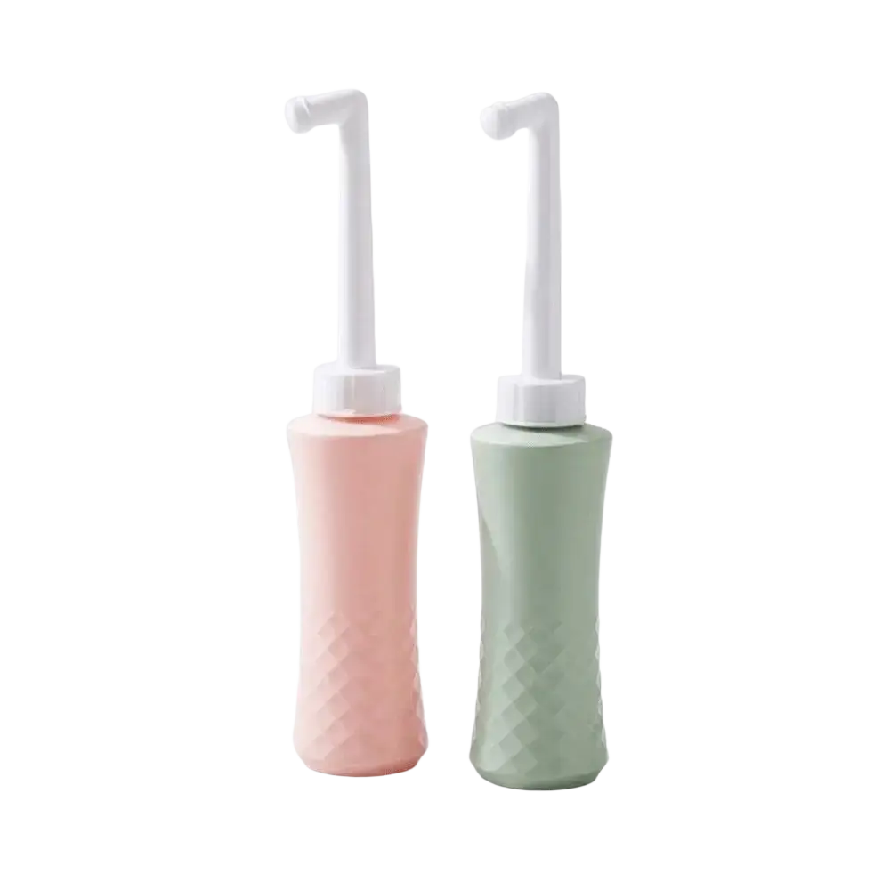 Two pastel nasal rinse wash bottles in pink and sage green with white nozzles and textured silicone bodies for easy squeeze use