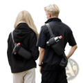 Black crossbody water bottle holder with red cap and silver buckle in minimalist fitness waist pack design