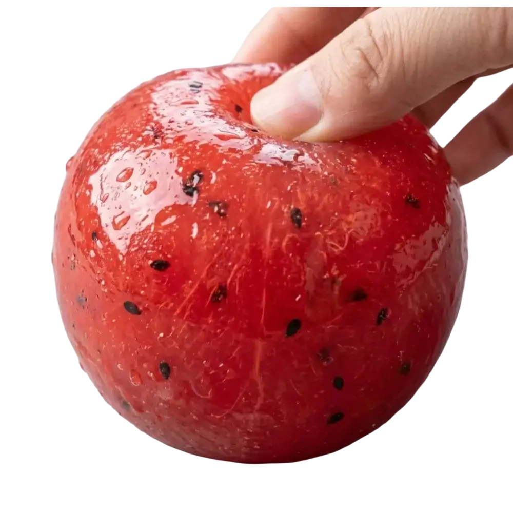 A glossy red handmade watermelon slush slow rebound stress relief toy shaped like a watermelon with black seeds