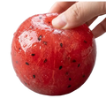 A glossy red handmade watermelon slush slow rebound stress relief toy shaped like a watermelon with black seeds
