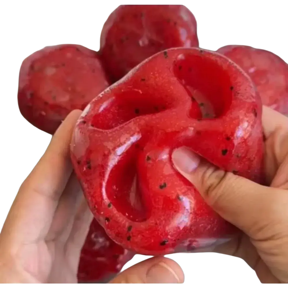 Red glossy handmade watermelon slush slow rebound stress ball shaped like dragon fruit with black seed speckles