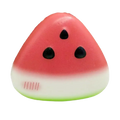 A triangular watermelon squeeze toy with a pink white gradient body black seeds and a green base slow rising stress reliever