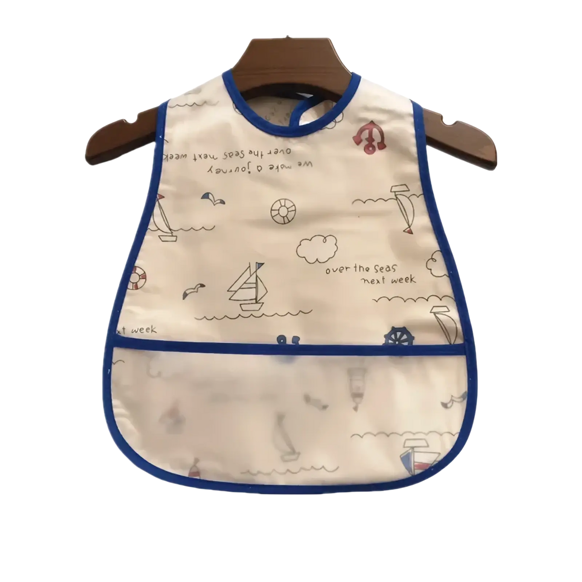 Cream-colored waterproof baby bib with blue trim and nautical sailboat illustrations for feeding protection