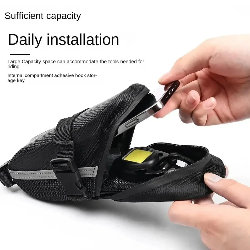 Black mesh waterproof bicycle saddle bag with gray reflective strip and adjustable strap for quick release cycling use
