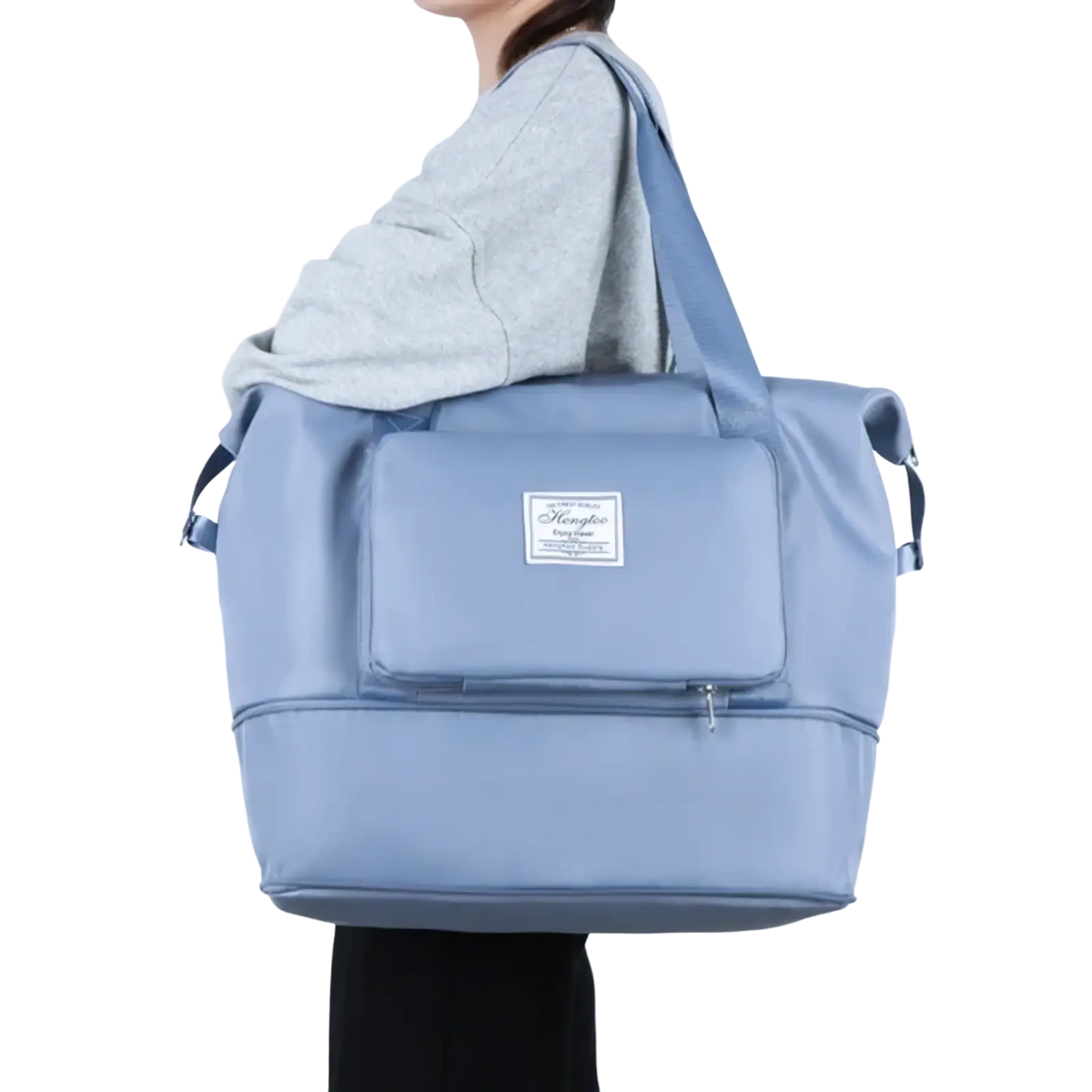 Light blue waterproof foldable travel duffel bag made of durable nylon with front zippered pocket and brand label