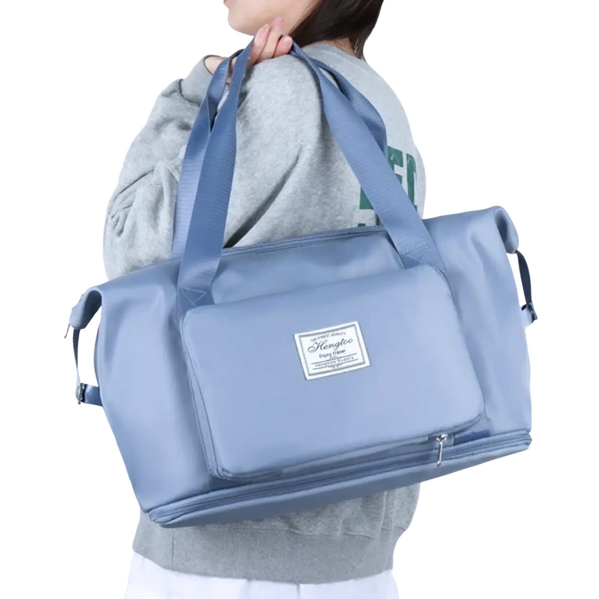 Light blue durable nylon waterproof foldable travel duffel bag with adjustable shoulder straps and front zippered pocket
