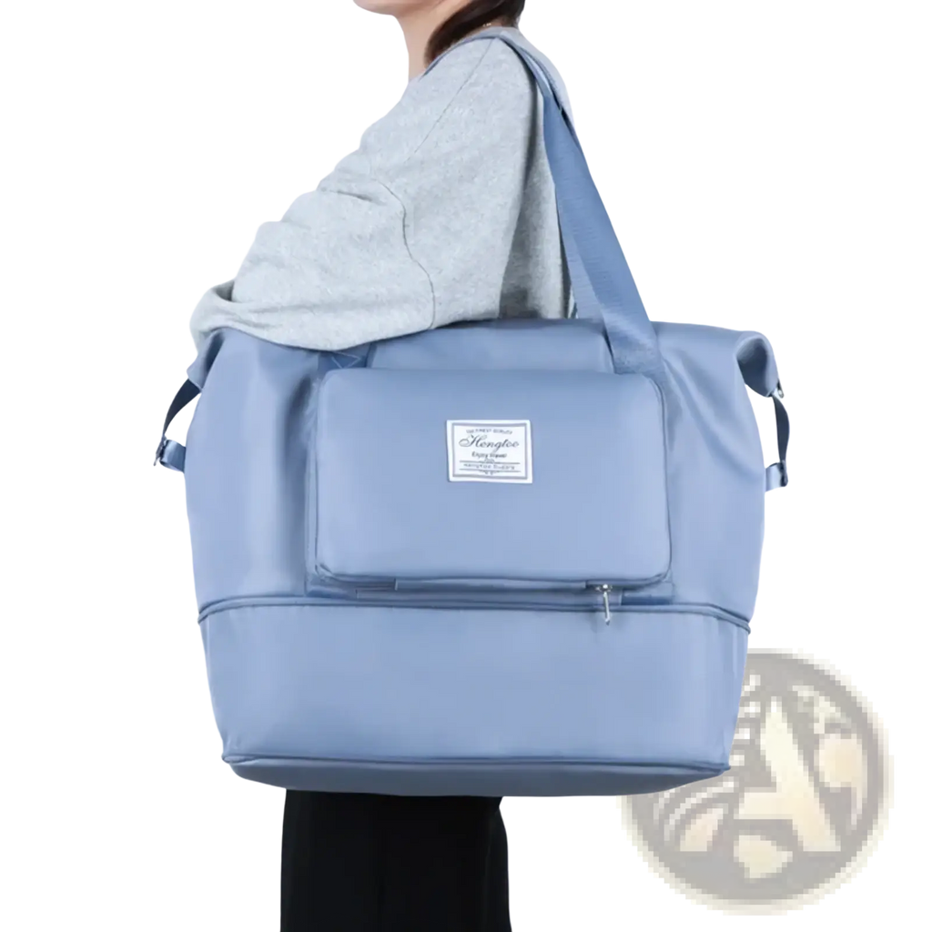 Light blue waterproof foldable travel duffel bag made of durable nylon with front zippered pocket and brand label