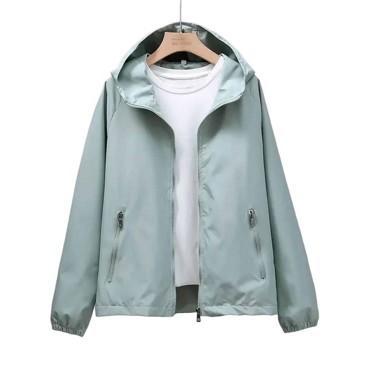 Waterproof hooded trench coat for women in light green with zippered pockets, elastic cuffs, and white t-shirt underneath