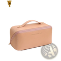 A blush pink waterproof leather travel makeup bag with gold hardware and embossed rose of no mans land text