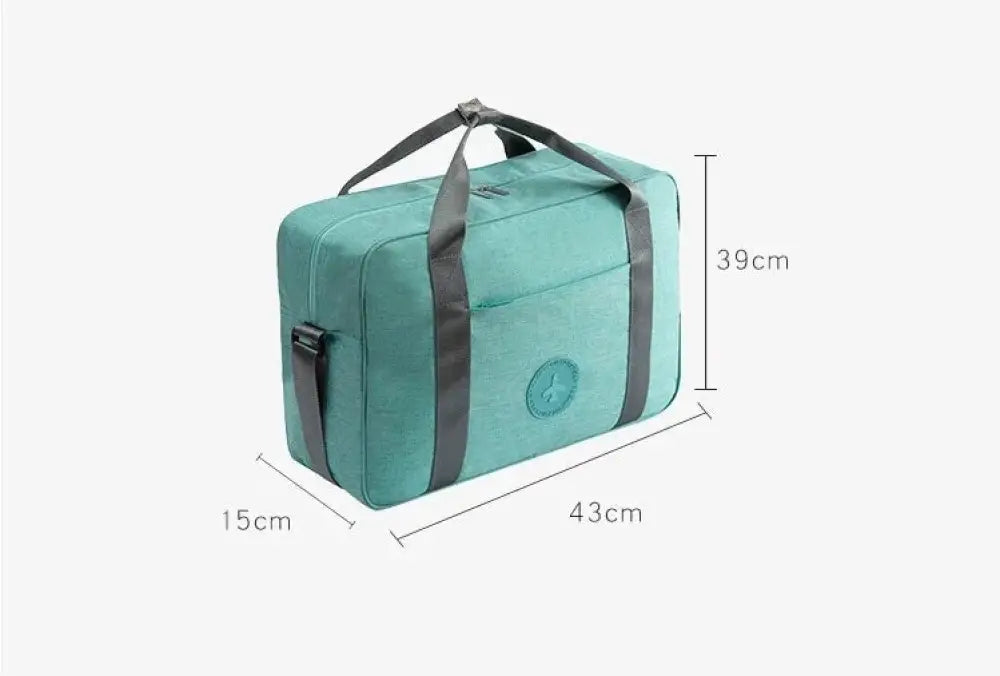 Teal waterproof dream travel shoe bag with reinforced handles, compact design, black straps, and circular front logo