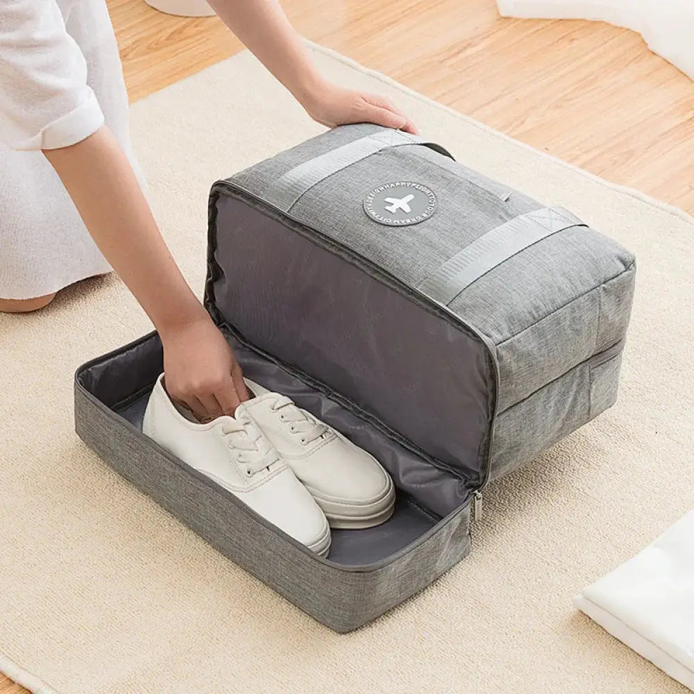 Gray textured fabric waterproof dream travel shoe bag with reinforced handles and circular logo patch