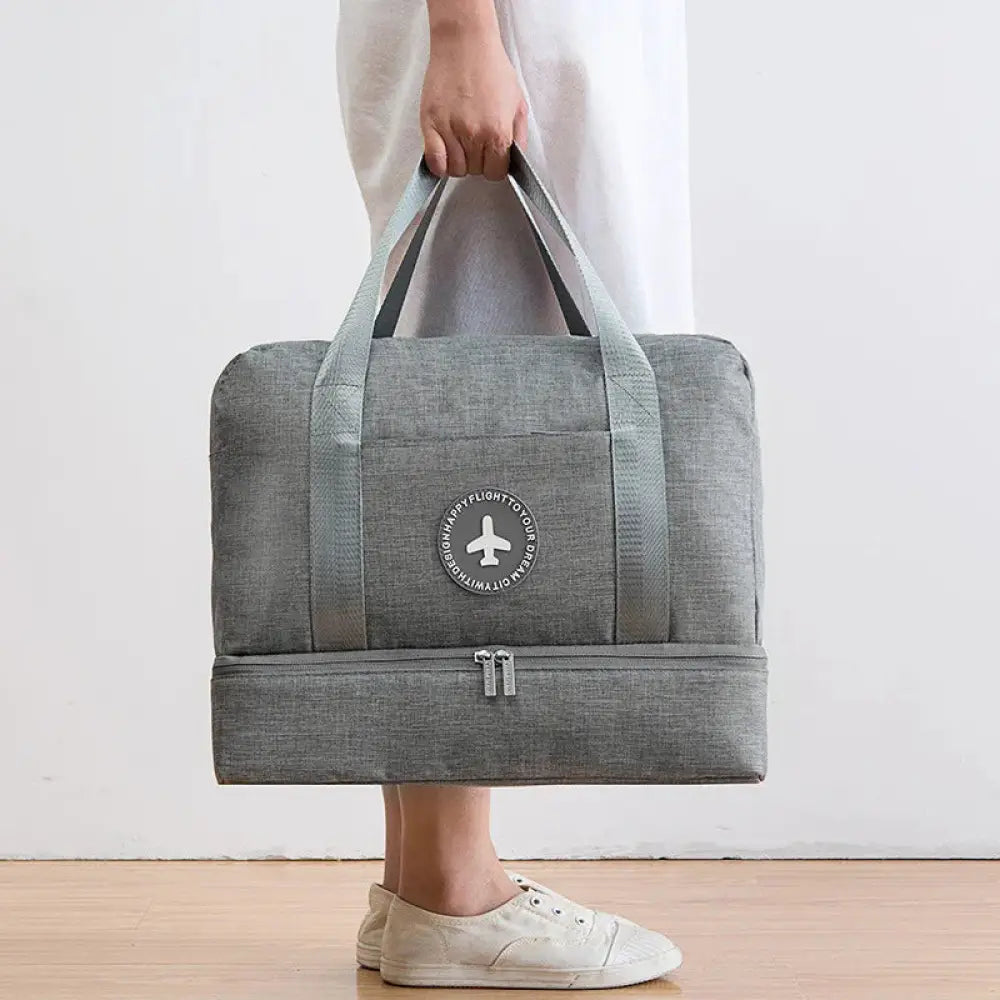 Gray textured waterproof dream travel shoe bag with reinforced sturdy handles and circular airplane logo patch
