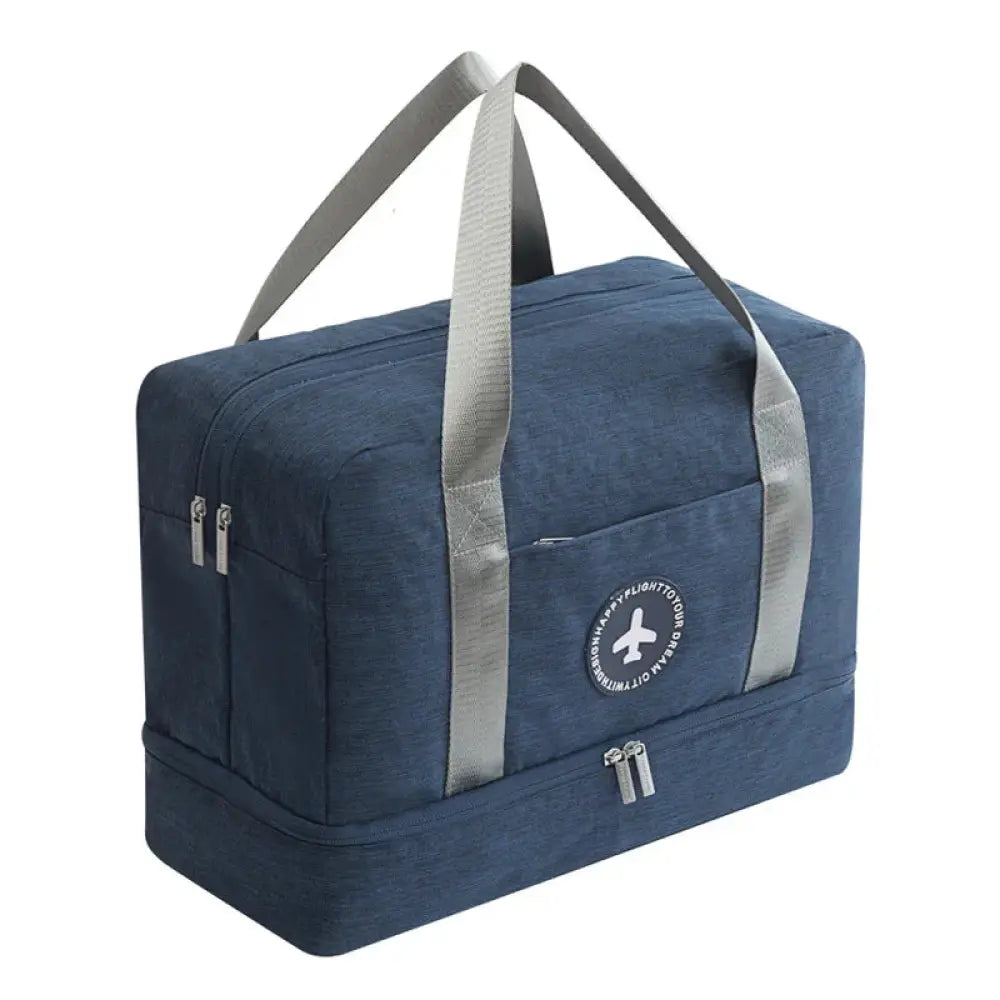 Navy blue waterproof dream travel shoe bag with gray webbing handles and circular airplane logo patch