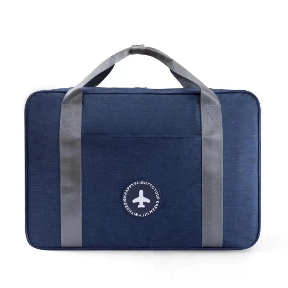 Navy blue waterproof dream travel shoe bag with gray reinforced handles and white airplane logo patch on front