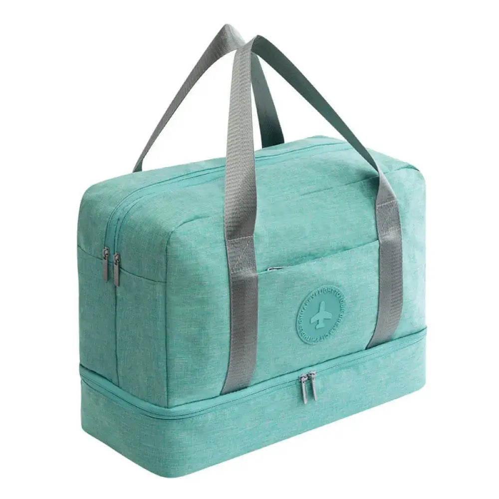 Teal two-tiered waterproof travel duffel shoe bag with reinforced gray fabric handles and circular logo patch