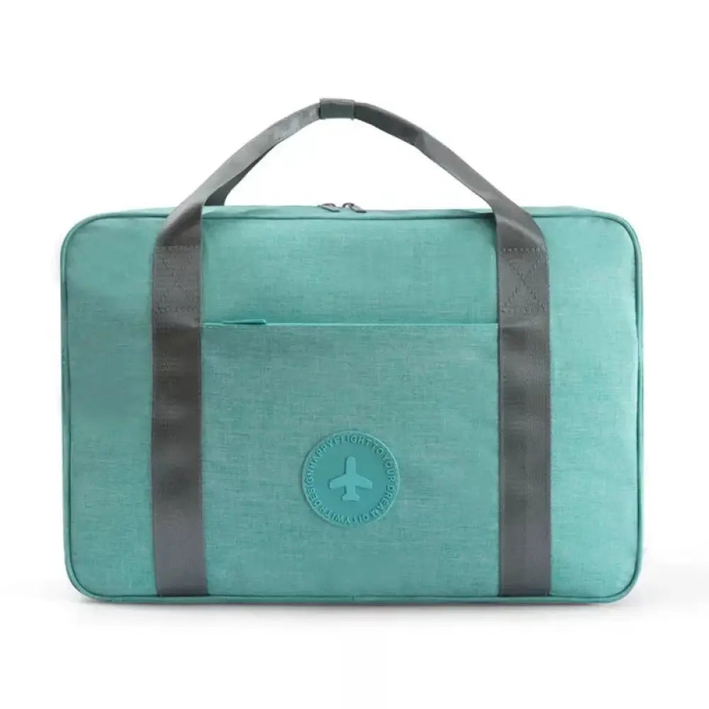 Teal waterproof dream travel shoe bag with gray fabric handles and airplane logo patch for organized packing