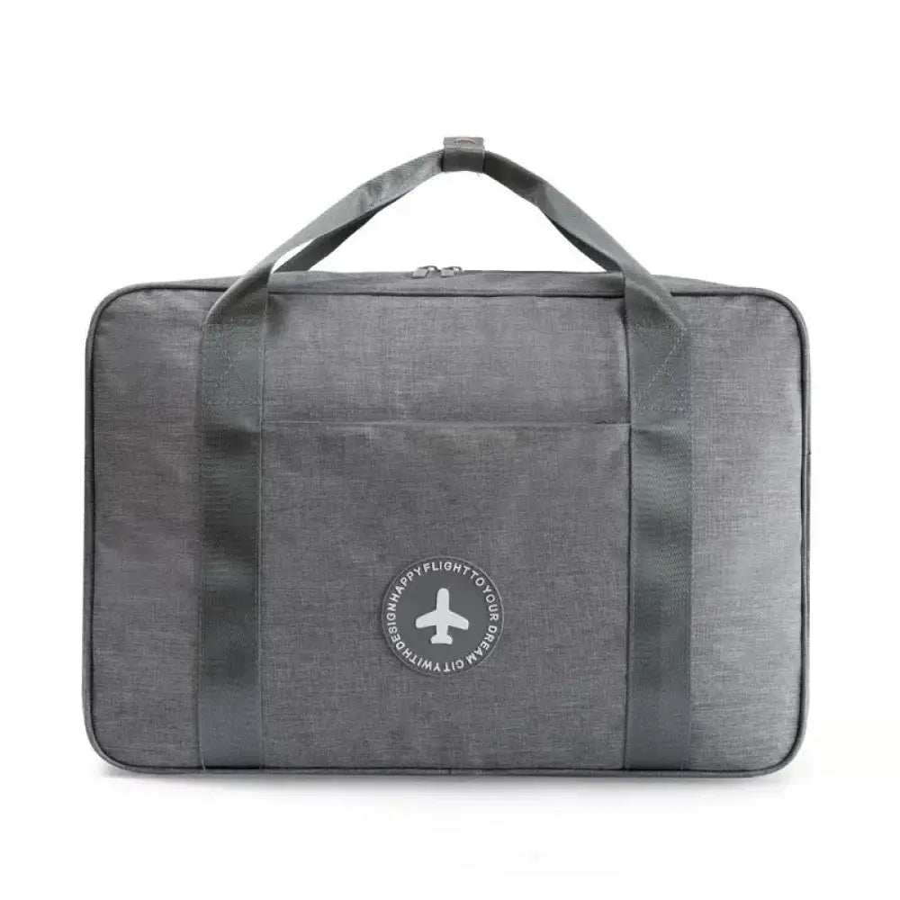 Gray textured waterproof dream travel shoe bag with reinforced handles and airplane logo patch on front side