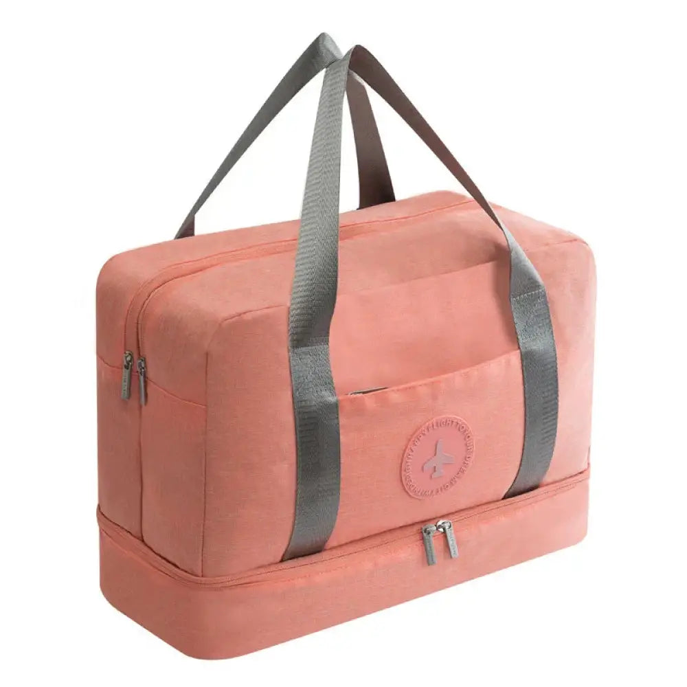 A coral-colored waterproof two-tiered travel shoe bag with reinforced gray fabric handles and a circular logo patch
