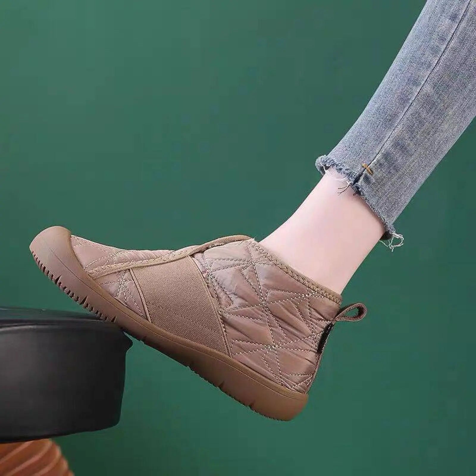 Beige quilted waterproof plush winter snow boot with padded textured upper and rubber sole for cold weather use