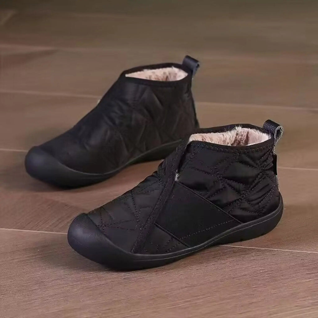 Black quilted waterproof plush winter snow boots with soft lining and durable rubber soles for ankle warmth and protection
