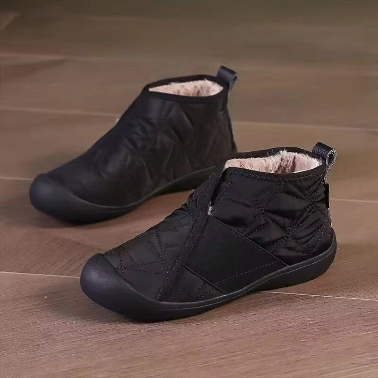 Black quilted waterproof plush winter snow boots with soft lining and durable rubber soles for ankle warmth and protection