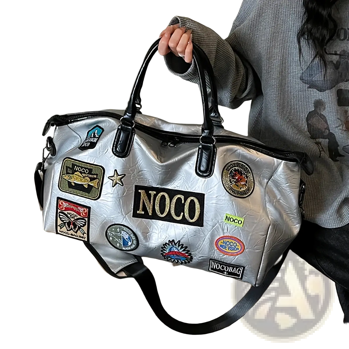 Silver metallic waterproof PU leather travel duffle bag with black leather handles and colorful noco embroidered patches