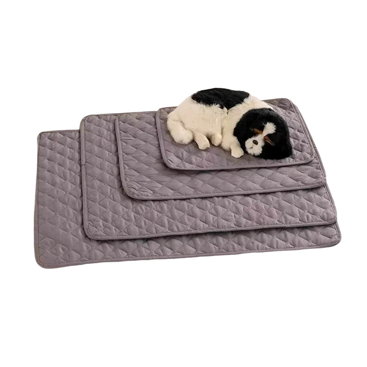 Set of three gray quilted waterproof pet bed mats with a black and white plush toy on top mat for furniture protection