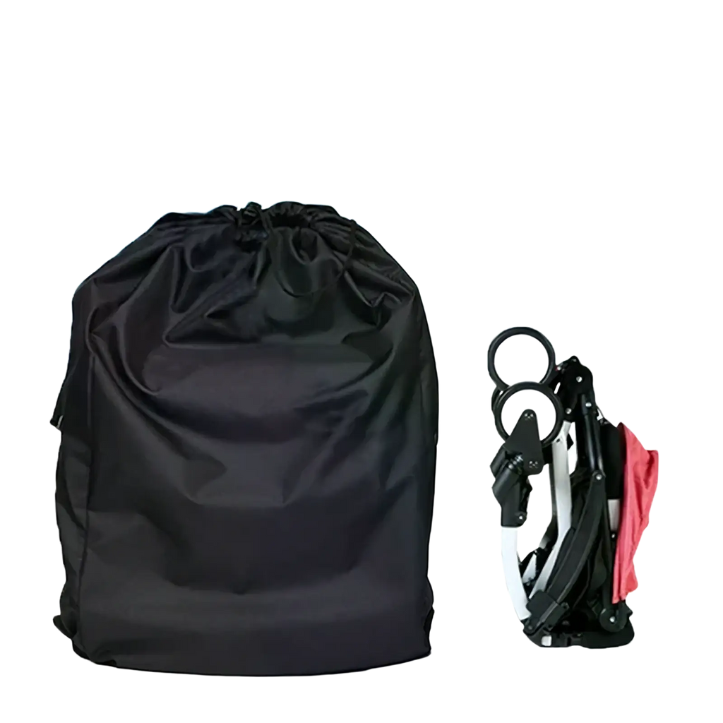 Black waterproof drawstring storage bag made of durable fabric next to a folded stroller for travel convenience