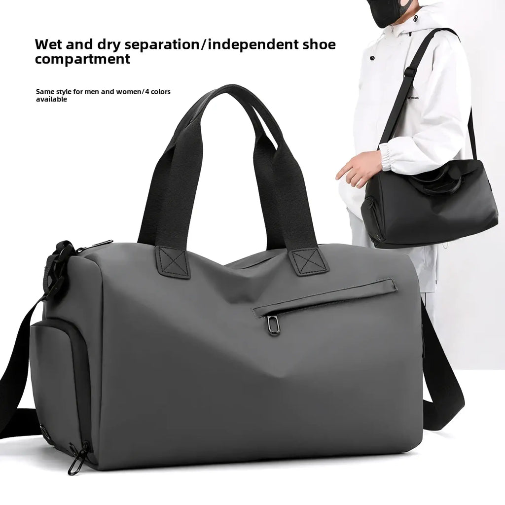 Gray waterproof travel duffel bag with black handles, shoulder strap, front zip pocket, and side shoe compartment