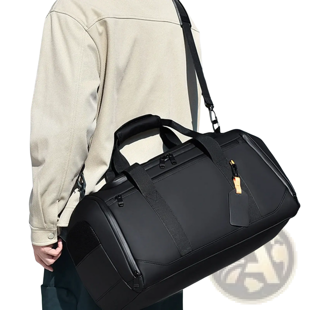 Black waterproof travel duffle bag with reinforced straps and gold-tone zipper pull for large capacity gym organization