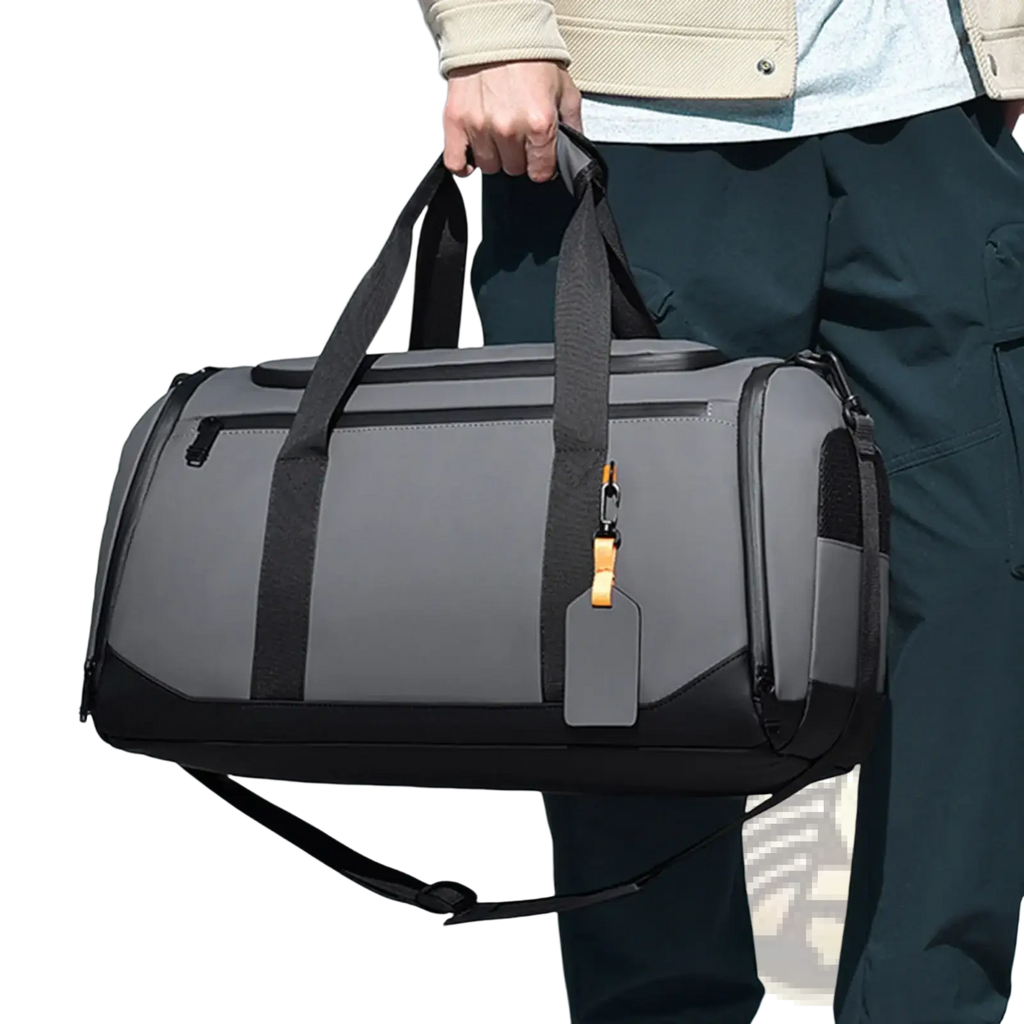 Gray and black waterproof travel duffle bag with reinforced handles and detachable shoulder strap for gym organization