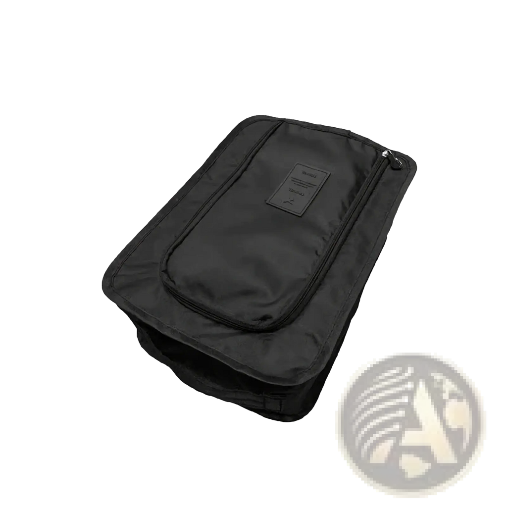 Black waterproof travel shoe storage bag with zippered front pocket and small rectangular label on exterior