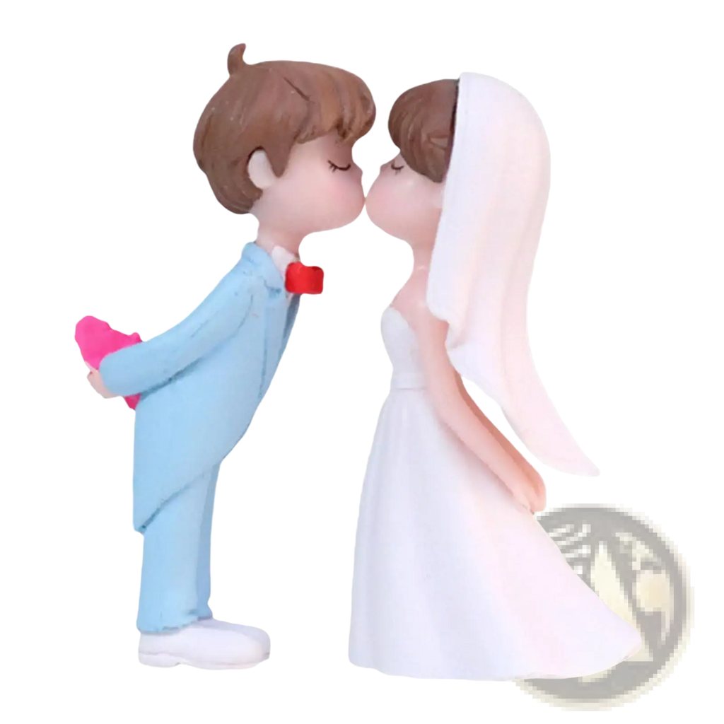 Cute resin wedding cake topper figurines of a bride in white gown and groom in light blue suit holding a pink heart