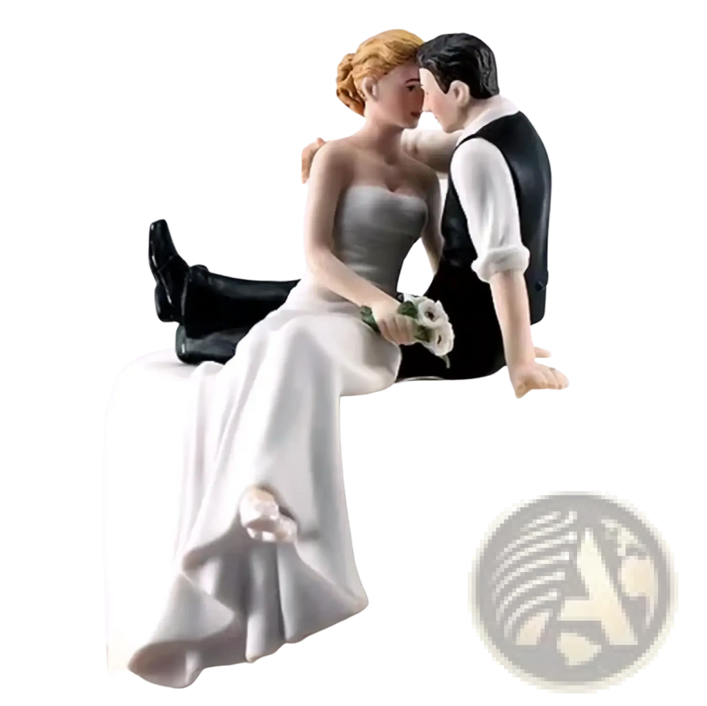 Detailed resin wedding cake topper featuring a bride in white gown and groom in black vest on frosted cake edge