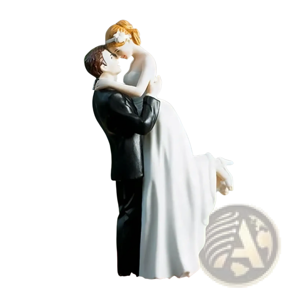 A detailed resin wedding cake topper featuring a bride in white gown and groom in black formal attire kissing intimately