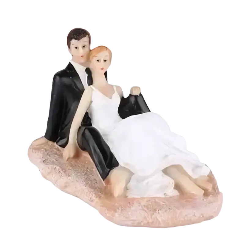 Wedding cake topper bride and groom resin figurine with glossy finish featuring a black suit groom and white lace gown bride