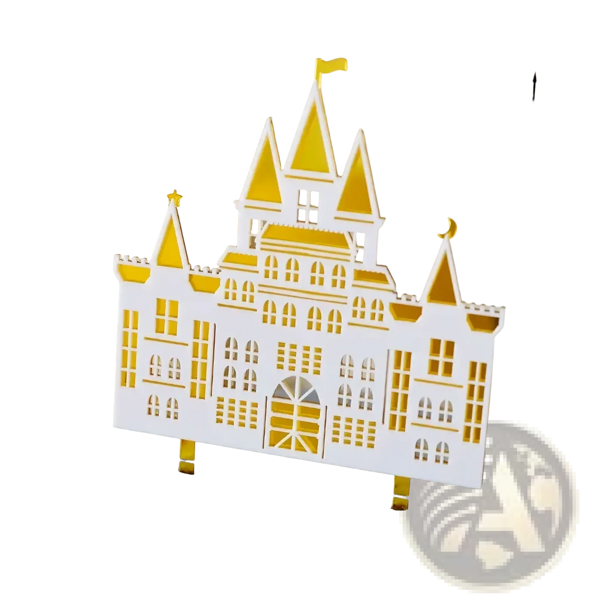 A white and gold acrylic wedding cake topper featuring a castle with intricate cut-out details for bride and groom decor